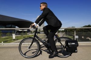Image: 0088386569, License: Rights managed, Businessman riding on an electric bicycle, pedelecs, Olympic Stadium, Munich, Bavaria, Germany, Europe, Property Release: No or not aplicable, Model Release: No or not aplicable, Credit line: Profimedia.cz, imagebroker
